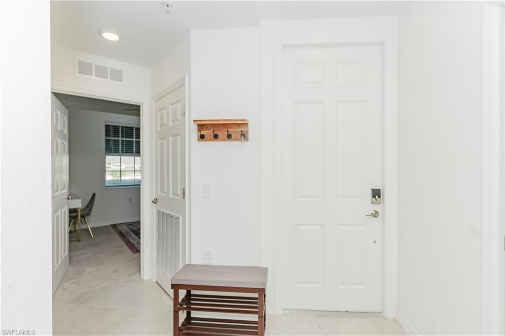 43993 Boardwalk Loop, Unit 1928 Babcock Ranch, FL 33982 - Photo 4 of 50 a view of a hallway with bathroom