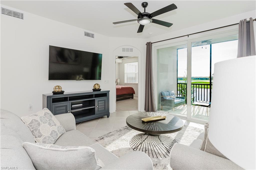 43993 Boardwalk Loop, Unit 1928 Babcock Ranch, FL 33982 - Photo 7 of 50 a living room with furniture and a flat screen tv