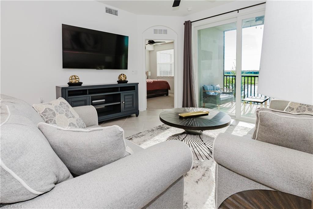 43993 Boardwalk Loop, Unit 1928 Babcock Ranch, FL 33982 - Photo 8 of 50 a living room with furniture and a flat screen tv