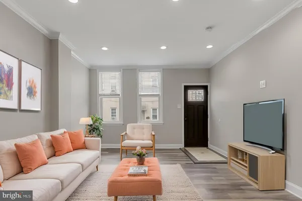 a living room with furniture and a flat screen tv