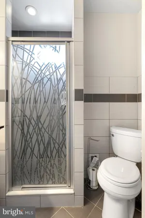a bathroom with a toilet and a shower