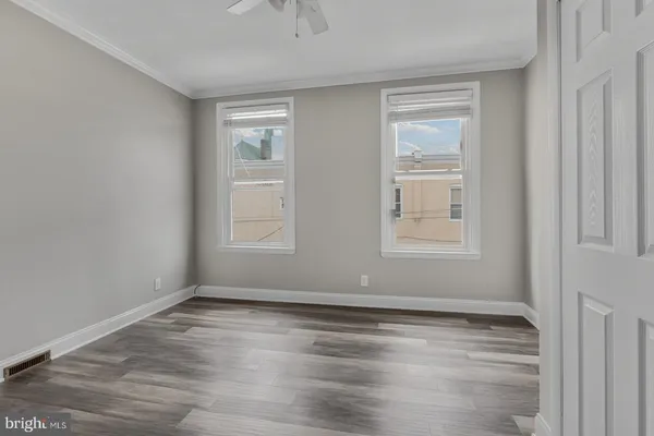 a view of room with window and wooden floor