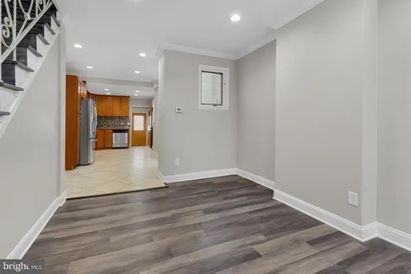 a view of empty room with wooden floor
