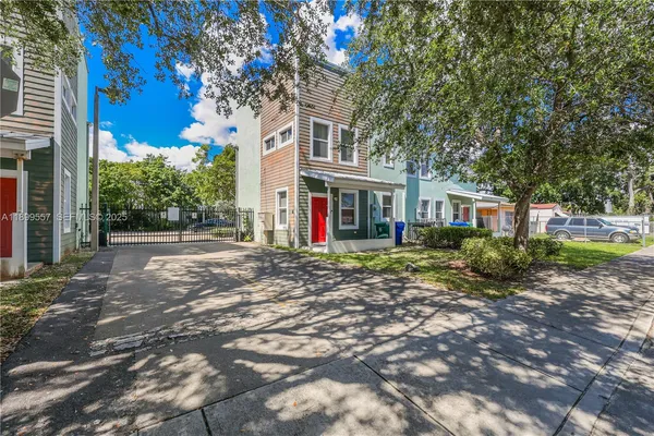 a view of a house with a tree in front