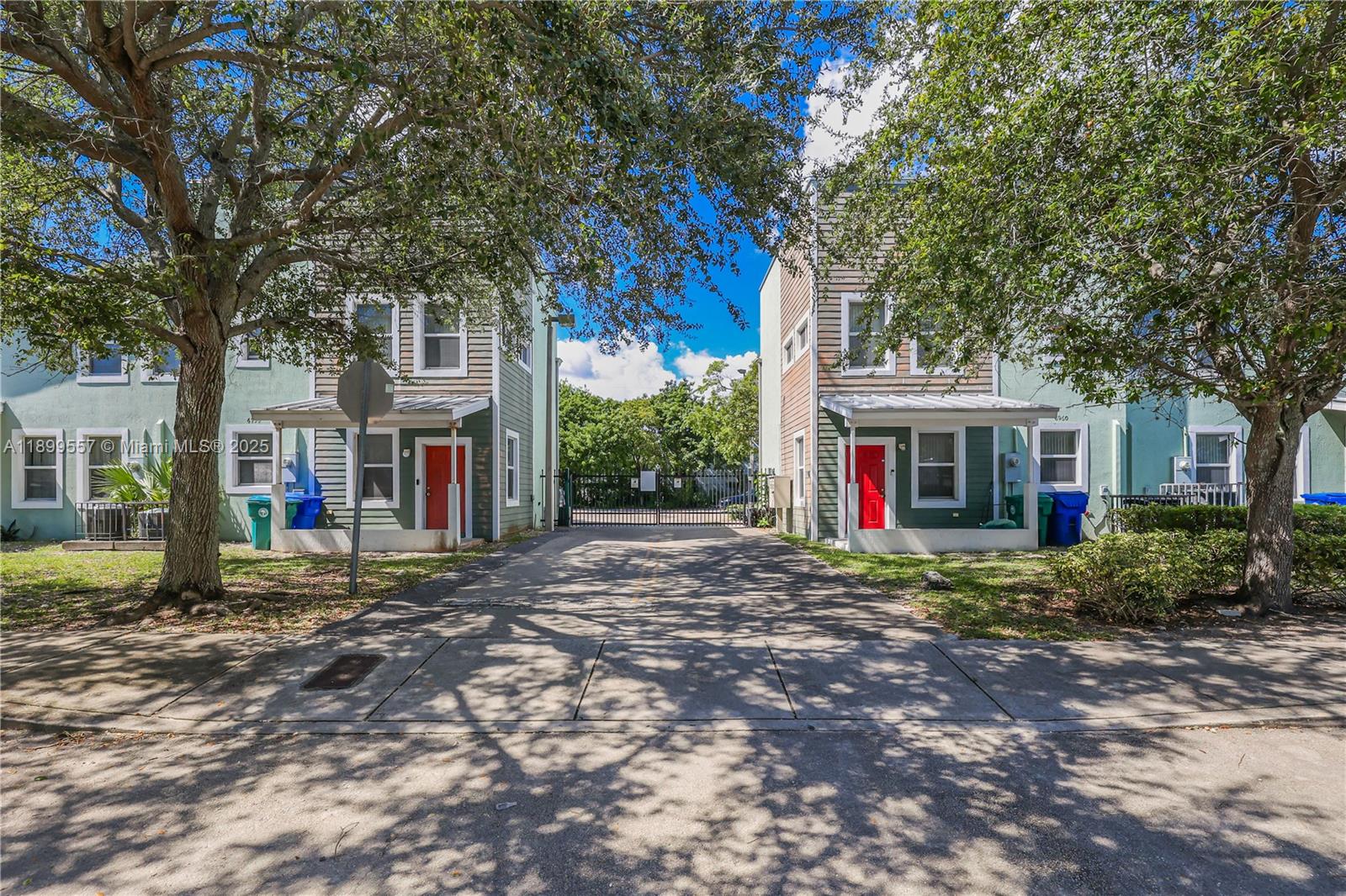 6960 Northwest 4th Avenue, Unit 3 Miami, FL 33150 - Photo 2 of 28 a view of road with large trees and a big yard