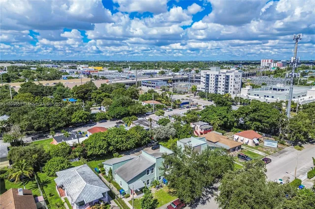an aerial view of residential houses with outdoor space and parking