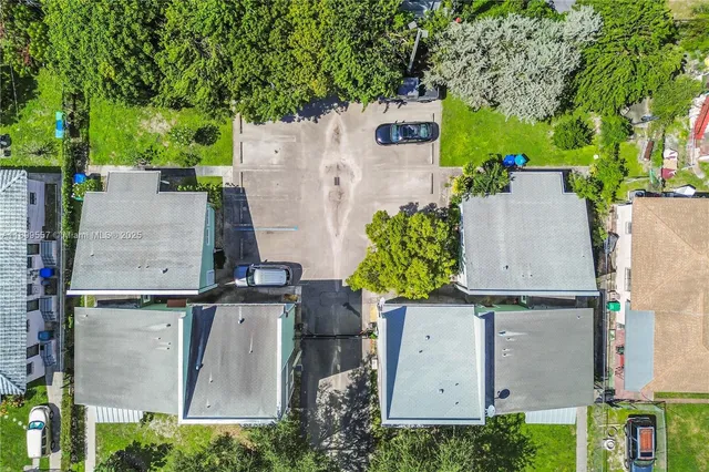 a view of a house with backyard sitting area and garden