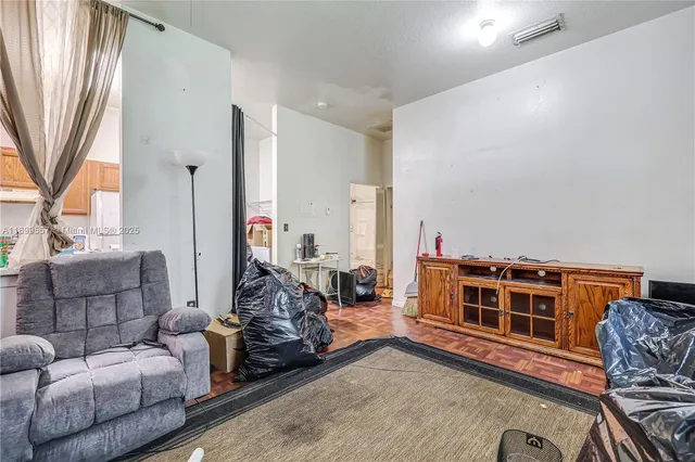 a room with furniture pool table and windows
