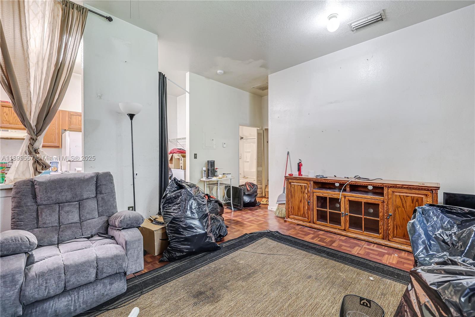 6960 Northwest 4th Avenue, Unit 3 Miami, FL 33150 - Photo 5 of 28 a living room with furniture and a flat screen tv