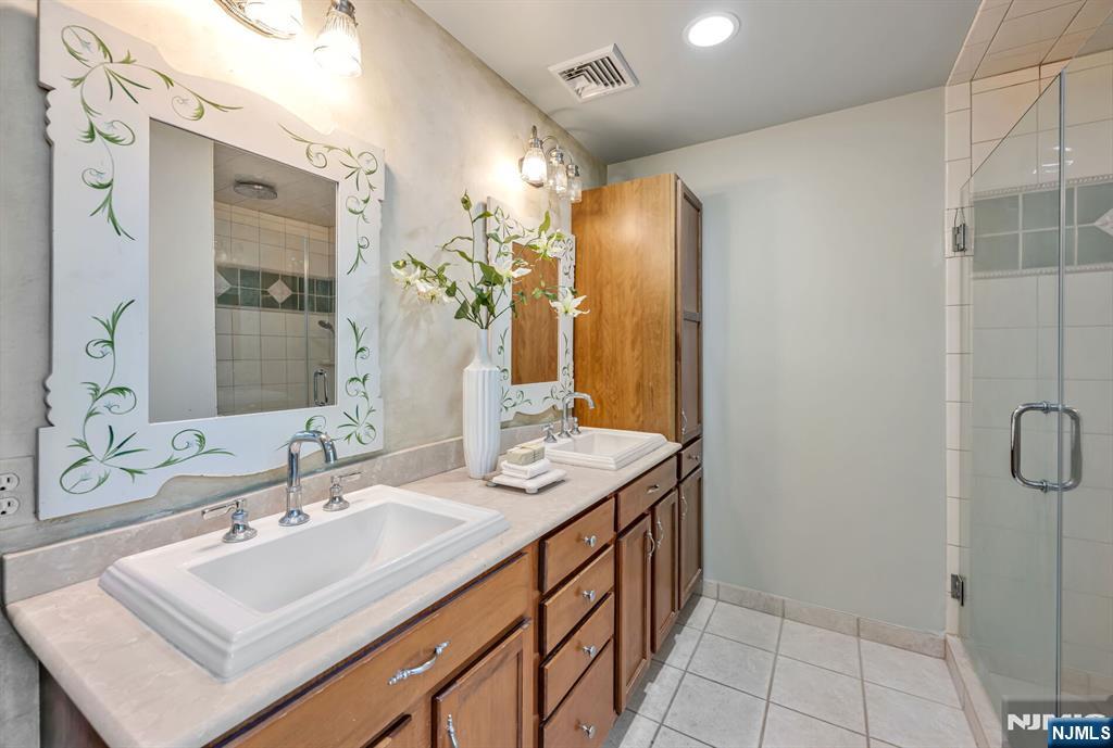 411 Snyder Road Wyckoff, NJ 07481 - Photo 21 of 36 a bathroom with a sink double vanity and a mirror