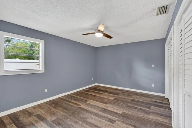 a view of room with window and ceiling fan