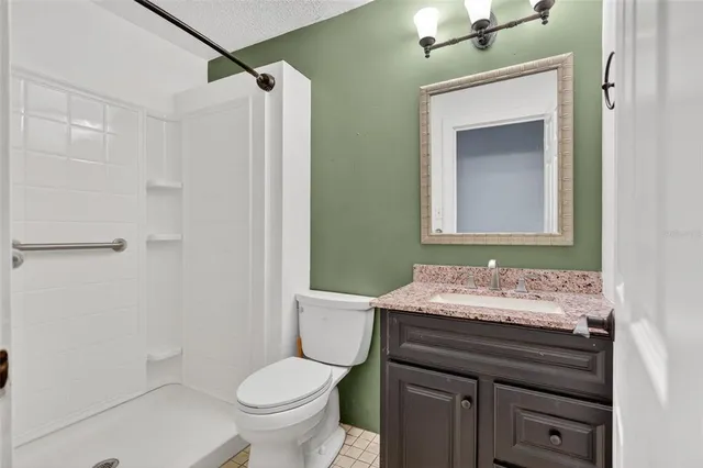 a bathroom with a sink vanity mirror and toilet