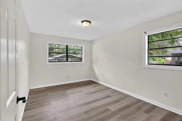 an empty room with windows and closet