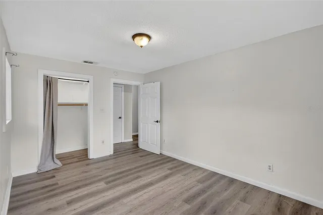 a view of an empty room and wooden floor