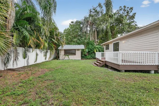 a view of a house with a yard and a porch