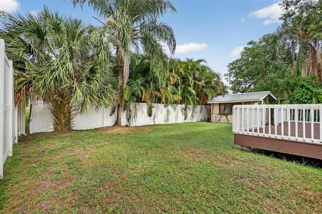 a view of a yard with large trees