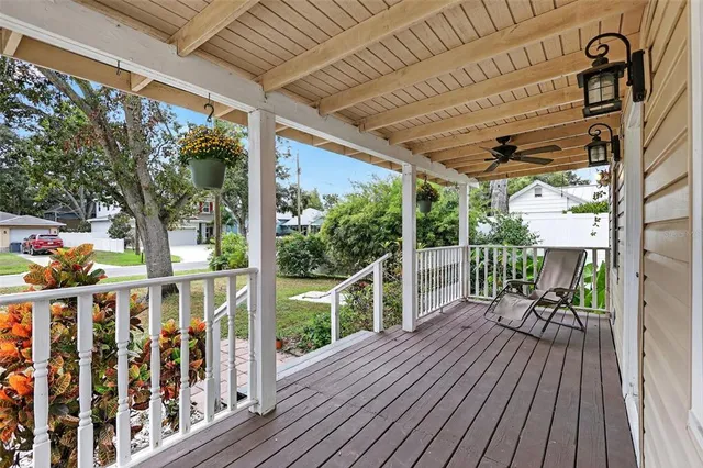 a view of balcony with furniture and wooden floor