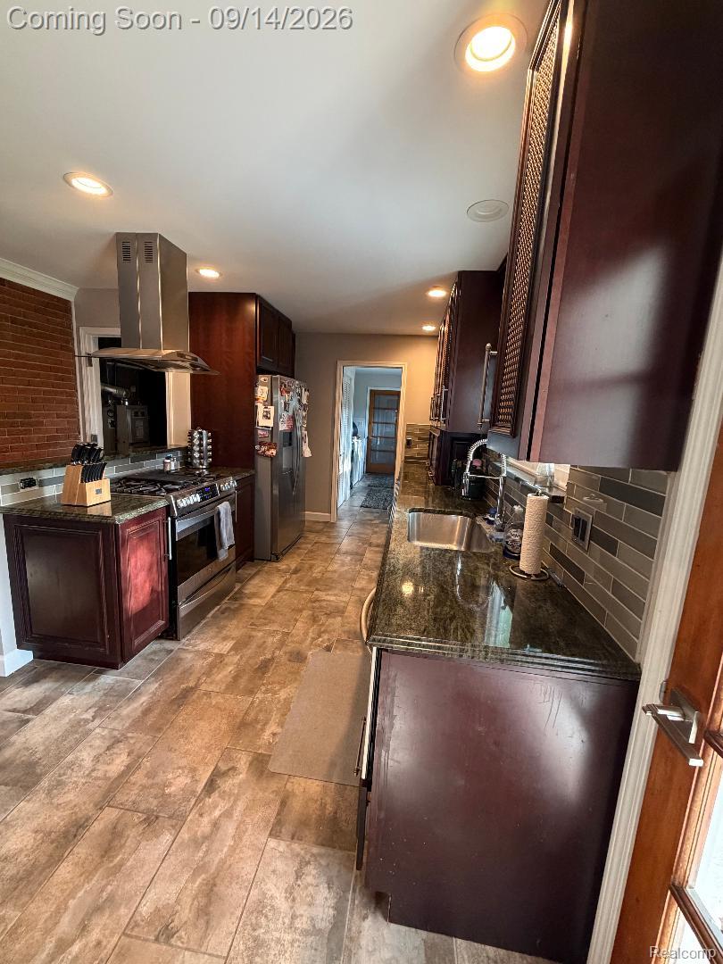 1615 Ladd Road Walled Lake, MI 48390 - Photo 12 of 28 Kitchen featuring rich wood-finish cabinetry, stone countertops, stainless steel appliances, a tile backsplash, and recessed lighting