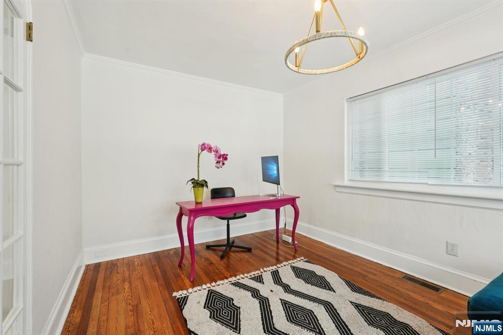 1486 Windsor Road Teaneck, NJ 07666 - Photo 11 of 24 a bedroom with a bed and a chandelier