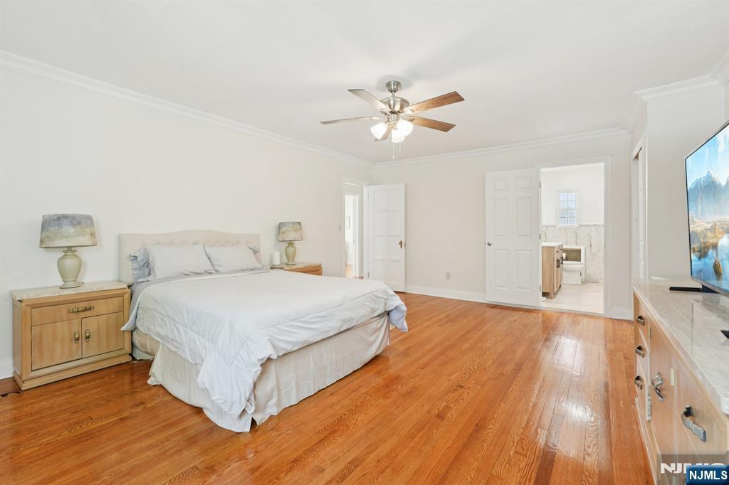 1486 Windsor Road Teaneck, NJ 07666 - Photo 13 of 24 a bedroom with a bed and a chandelier