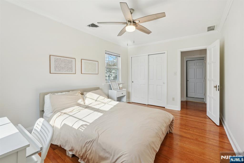 1486 Windsor Road Teaneck, NJ 07666 - Photo 17 of 24 a bedroom with a large bed and a ceiling fan