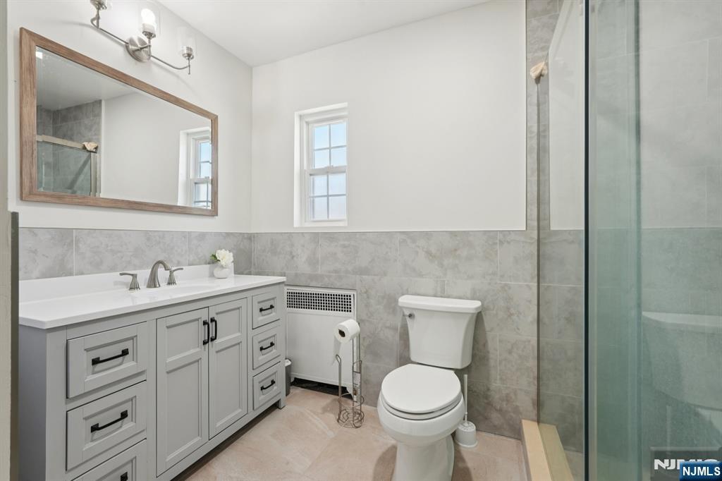 1486 Windsor Road Teaneck, NJ 07666 - Photo 18 of 24 a bathroom with a toilet sink and mirror