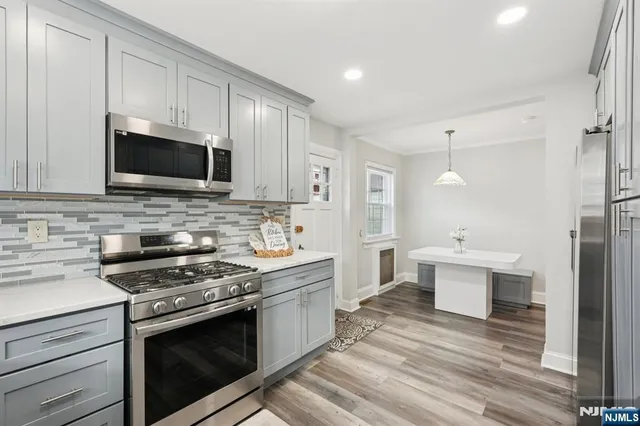 a kitchen with stainless steel appliances a stove microwave and cabinets