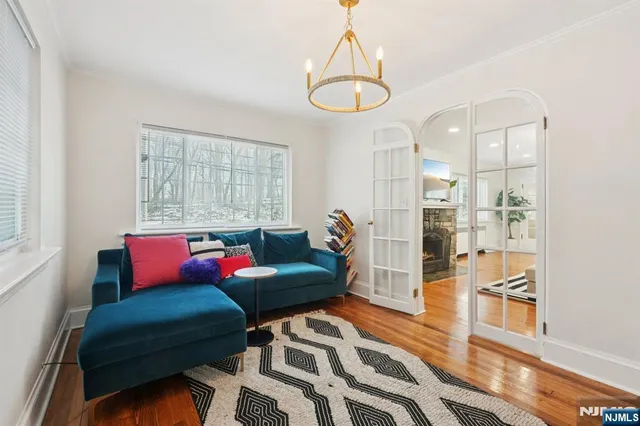 a living room with furniture and a chandelier