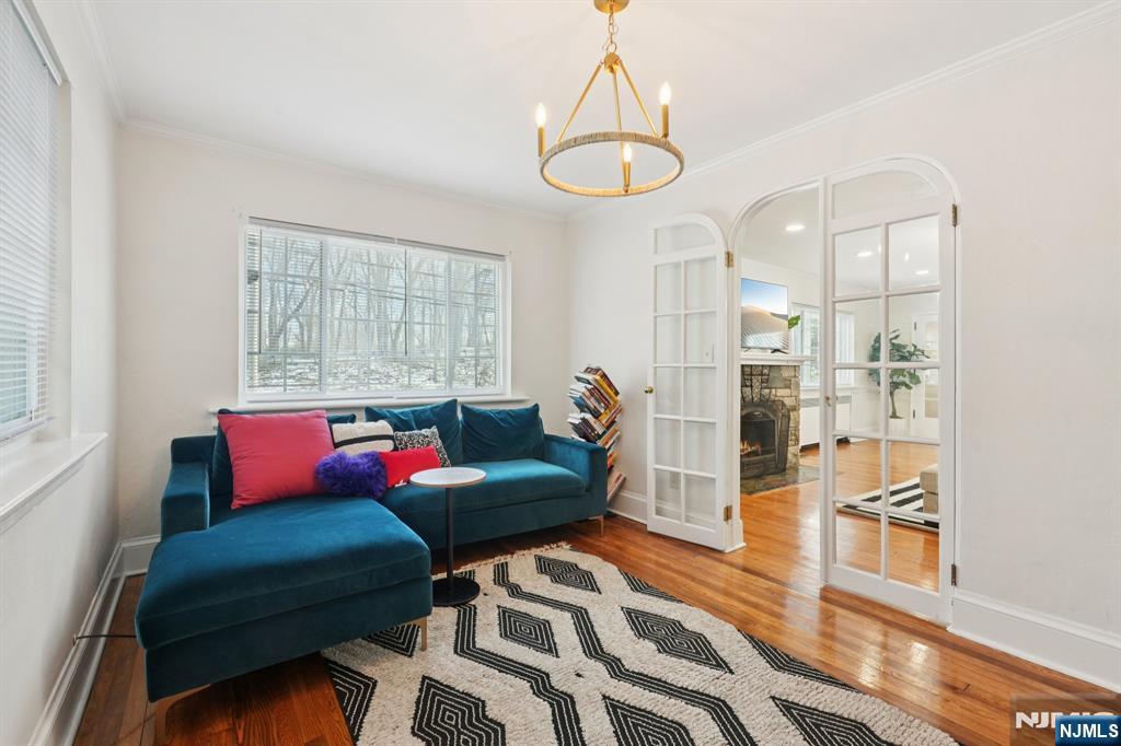 1486 Windsor Road Teaneck, NJ 07666 - Photo 10 of 24 a living room with furniture and a chandelier