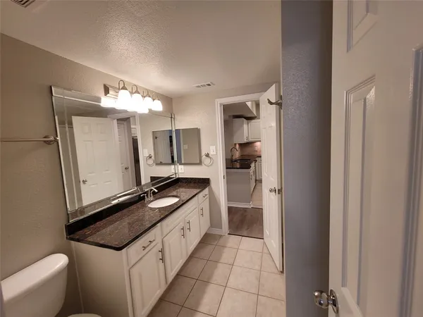 a kitchen with stainless steel appliances granite countertop a sink and a refrigerator