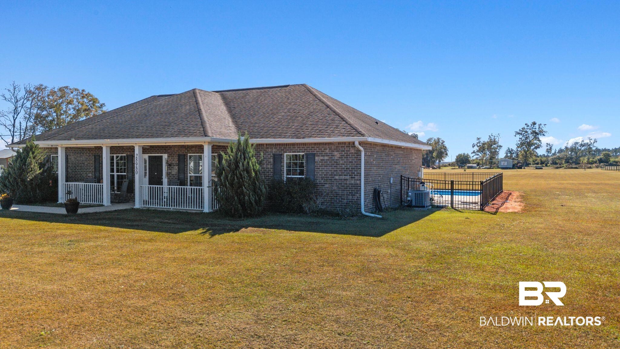 28980 Comstock Road Elberta, AL 36530 - Photo 36 of 38 View of property exterior featuring brick siding and a central AC unit
