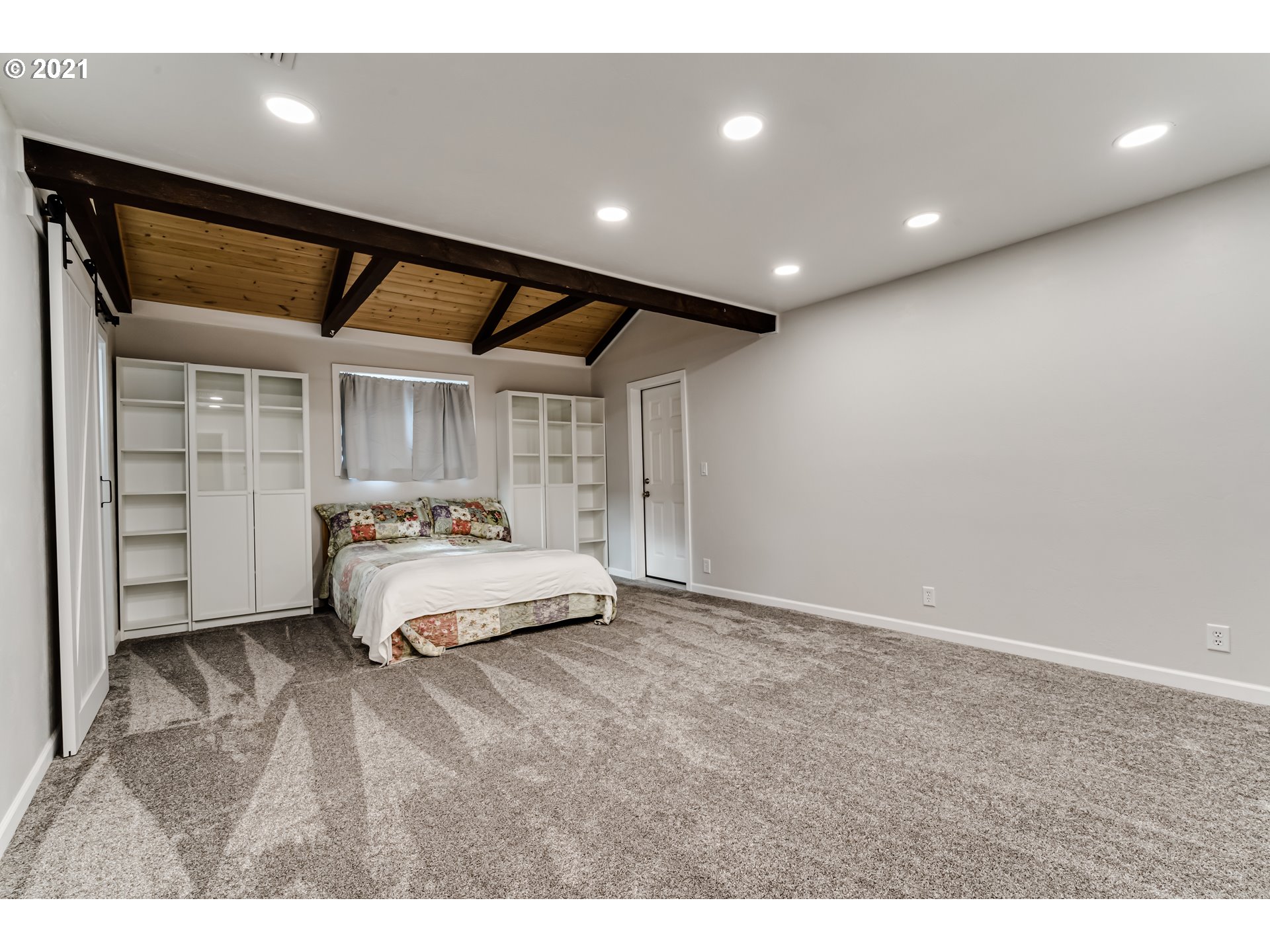 1438 I Street Springfield, OR 97477 - Photo 15 of 32 a spacious bedroom with a bed and a large window