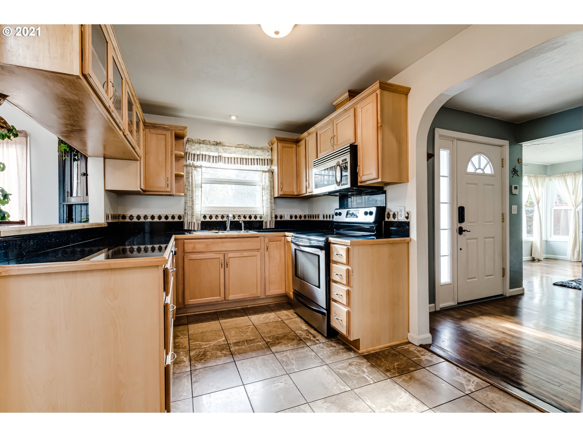 1438 I Street Springfield, OR 97477 - Photo 5 of 32 a kitchen with granite countertop a stove top oven a sink a counter top space and cabinets