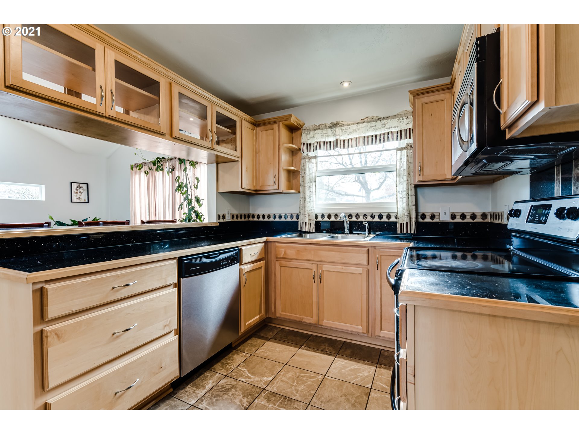 1438 I Street Springfield, OR 97477 - Photo 6 of 32 a kitchen with stainless steel appliances granite countertop a stove a sink and a microwave