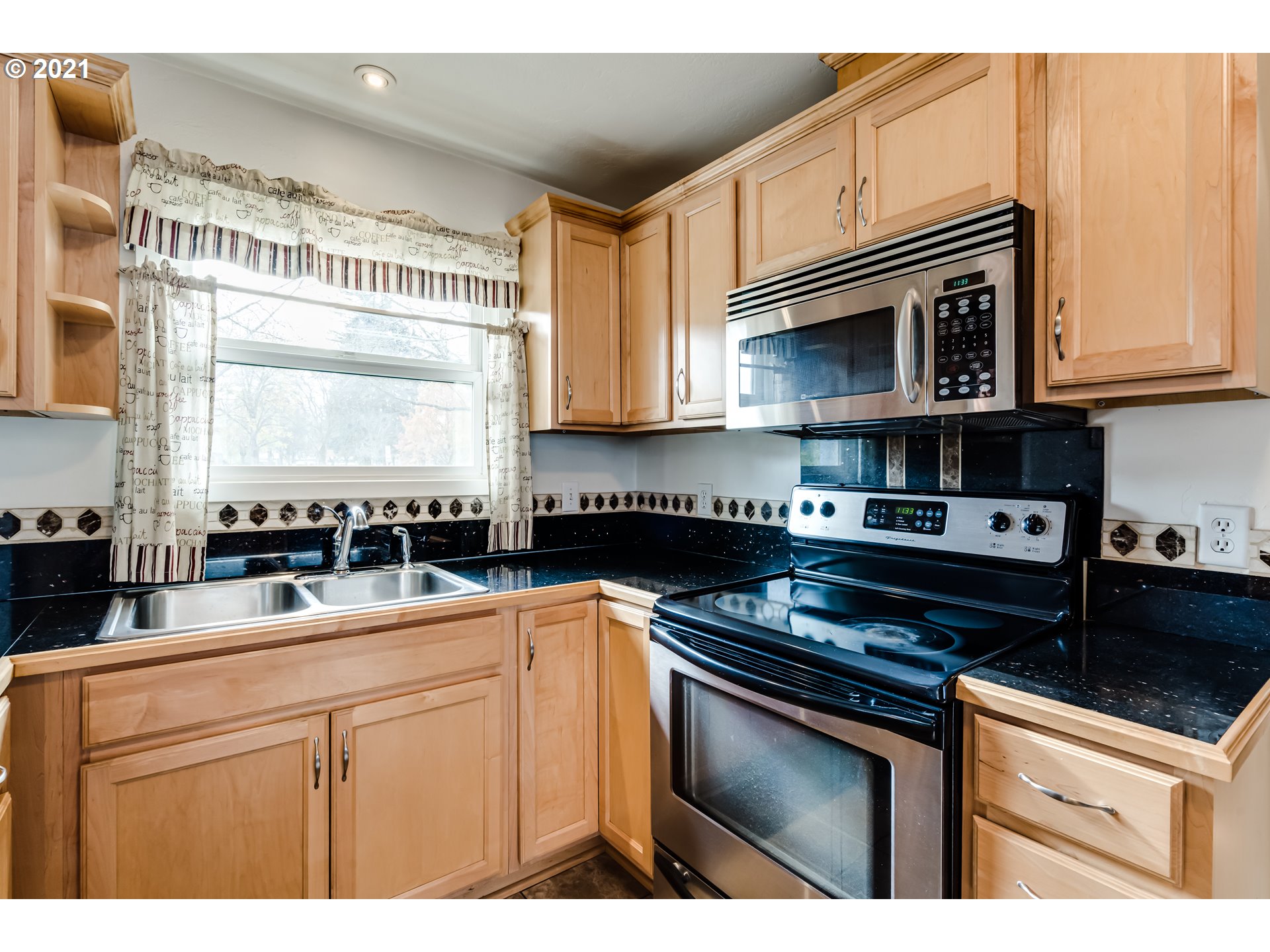 1438 I Street Springfield, OR 97477 - Photo 7 of 32 a kitchen with stainless steel appliances granite countertop a sink stove and cabinets
