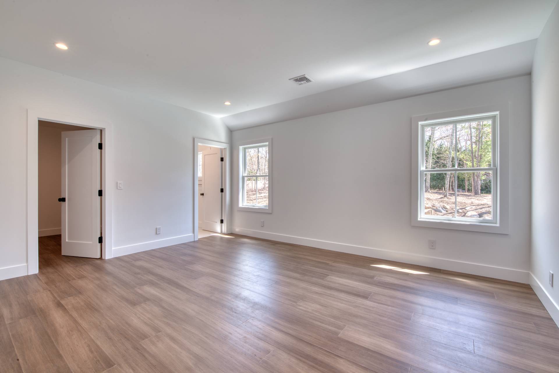 18 Barnes Avenue East Hampton, NY 11937 - Photo 18 of 35 an empty room with wooden floor and windows