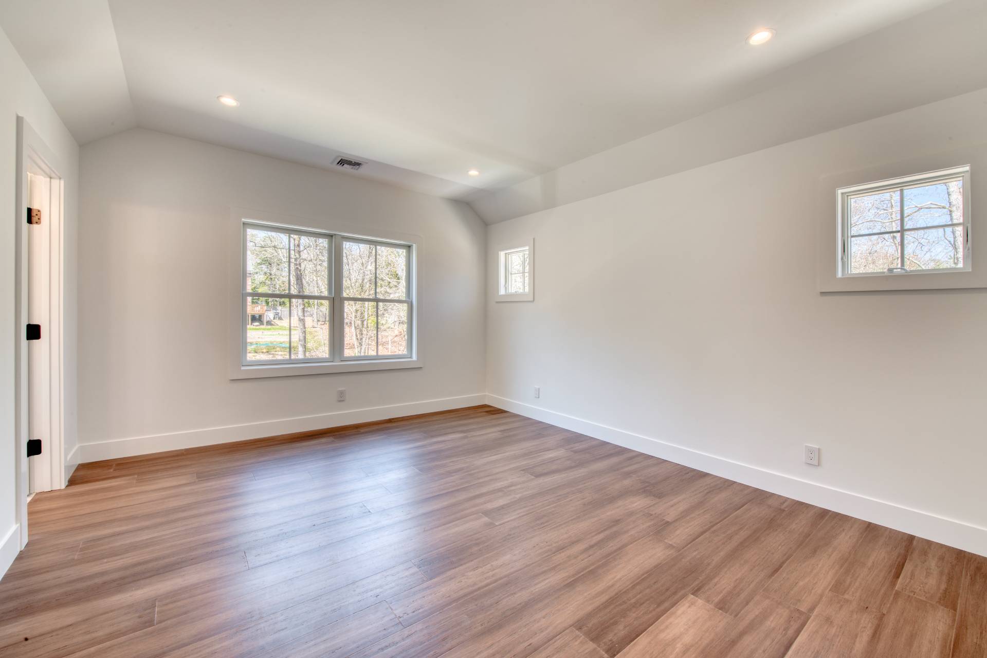 18 Barnes Avenue East Hampton, NY 11937 - Photo 21 of 35 an empty room with wooden floor and windows