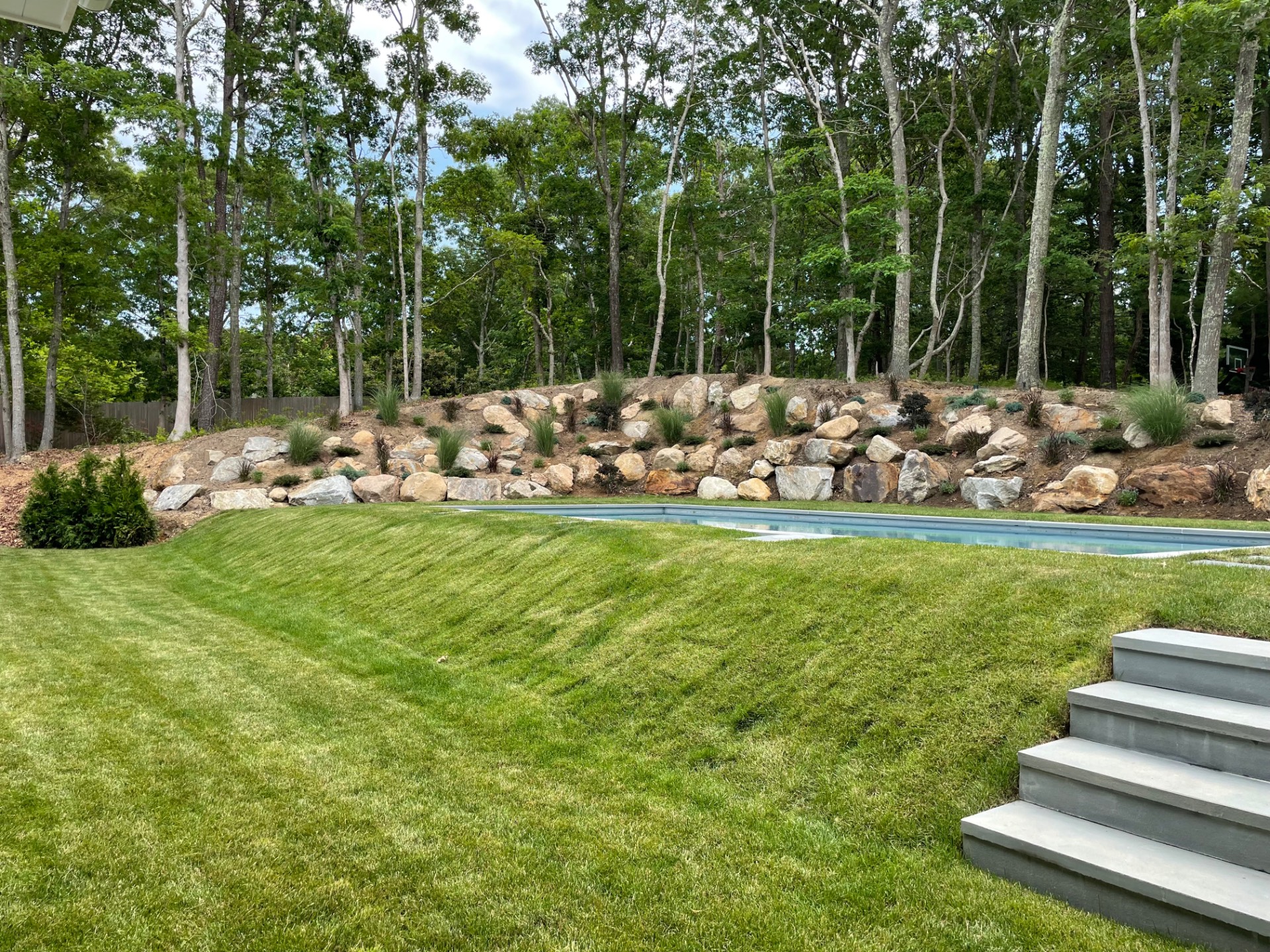 18 Barnes Avenue East Hampton, NY 11937 - Photo 34 of 35 a view of a lake with lawn chairs and large trees