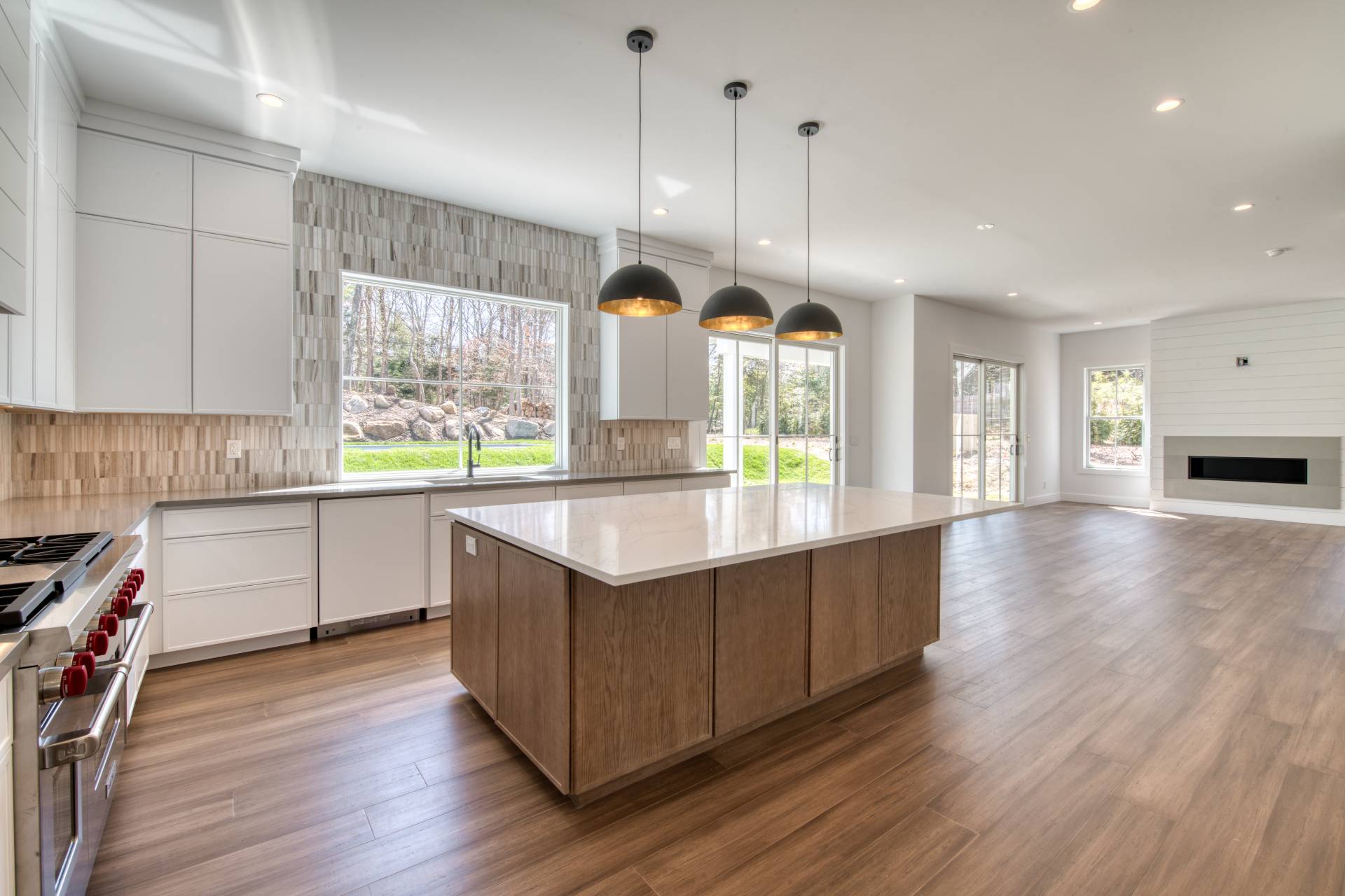 18 Barnes Avenue East Hampton, NY 11937 - Photo 8 of 35 a kitchen with stainless steel appliances granite countertop wooden floors sink and window