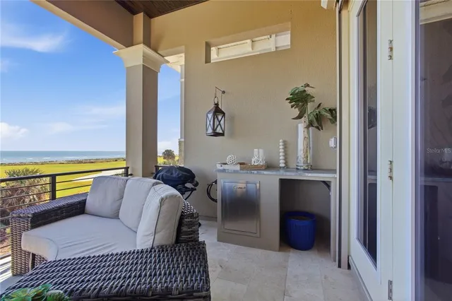 a bedroom with a bed a chandelier and a couch