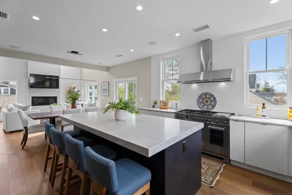 a kitchen with a stove a refrigerator and a dining table
