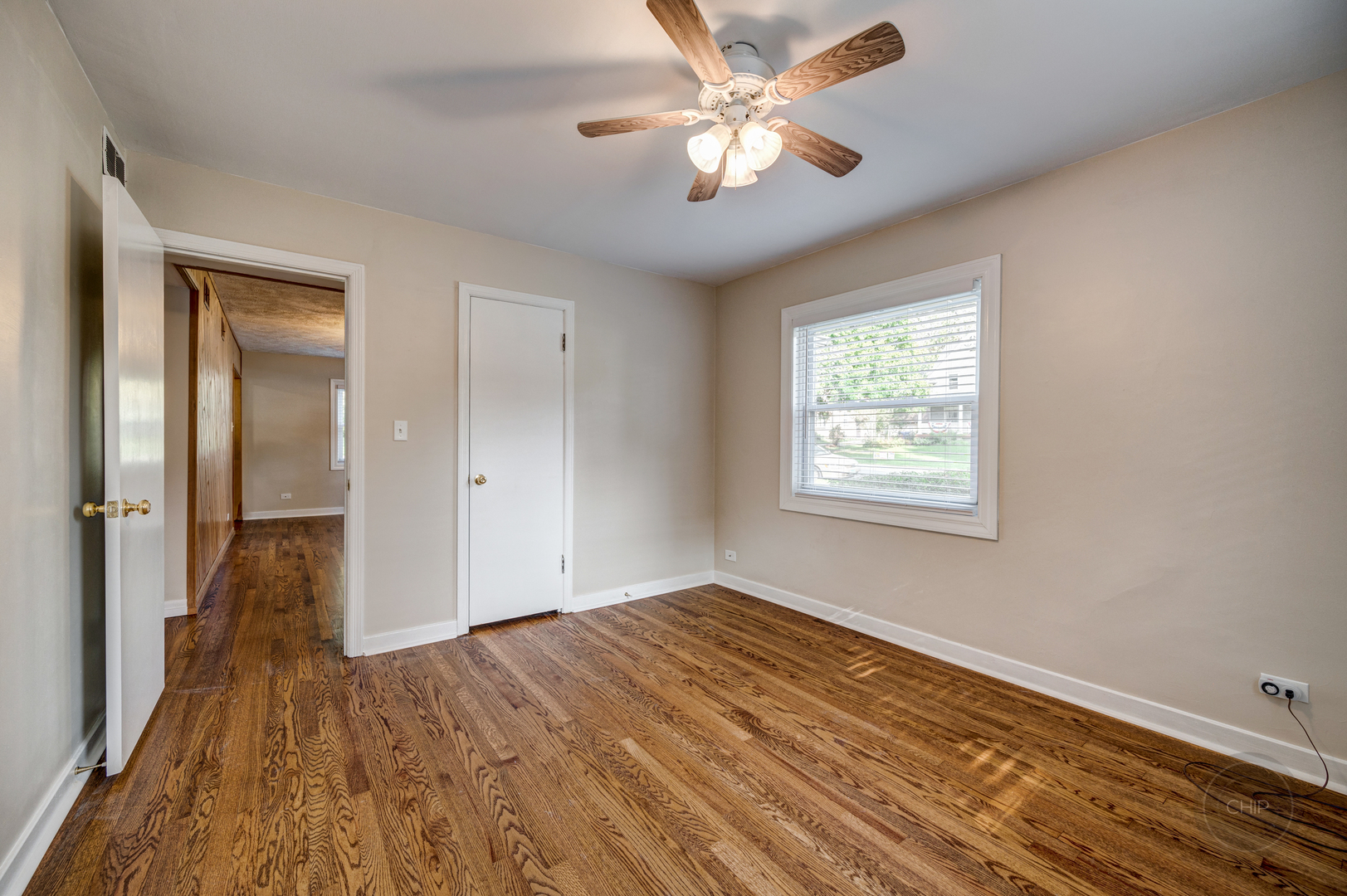 843 Pick Street Wheaton, IL 60187 - Photo 14 of 33 wooden floor in an empty room with a window