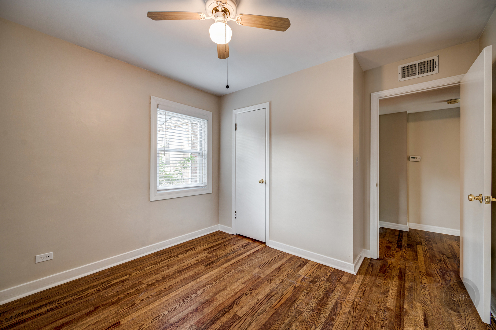 843 Pick Street Wheaton, IL 60187 - Photo 16 of 33 a view of a room with wooden floor and a ceiling fan