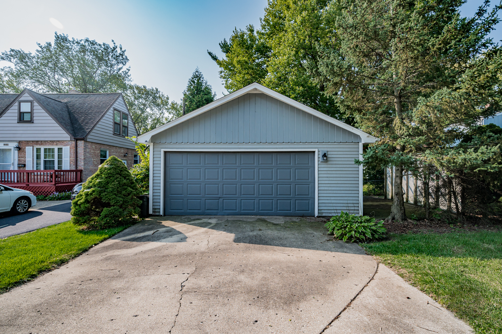 843 Pick Street Wheaton, IL 60187 - Photo 28 of 33 a view of a house with a small yard plants and a large tree
