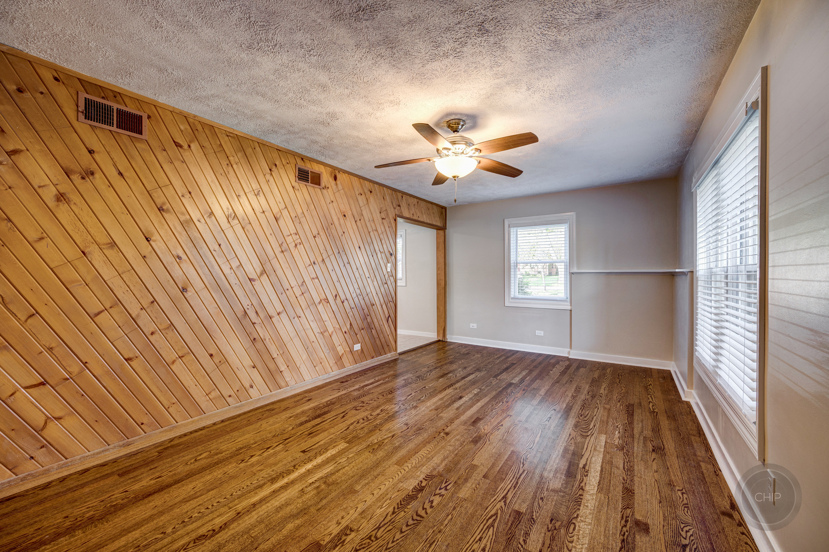 843 Pick Street Wheaton, IL 60187 - Photo 4 of 33 wooden floor in an empty room with a window
