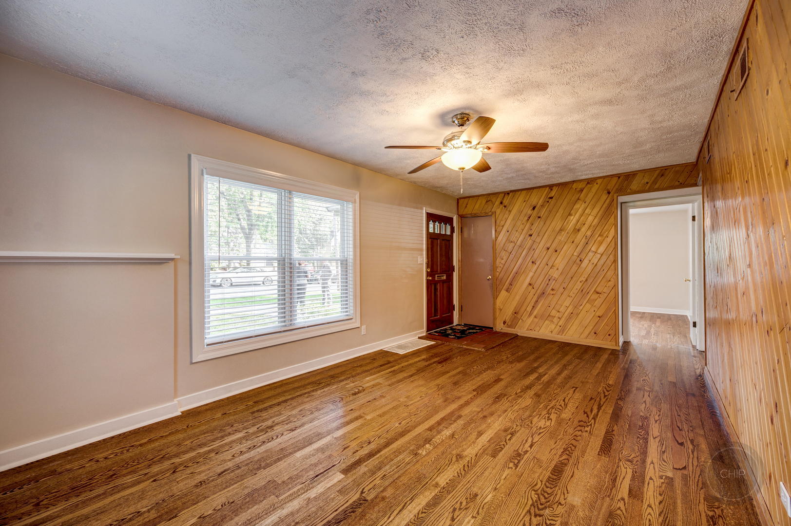 843 Pick Street Wheaton, IL 60187 - Photo 5 of 33 a view of an empty room with a window and wooden floor