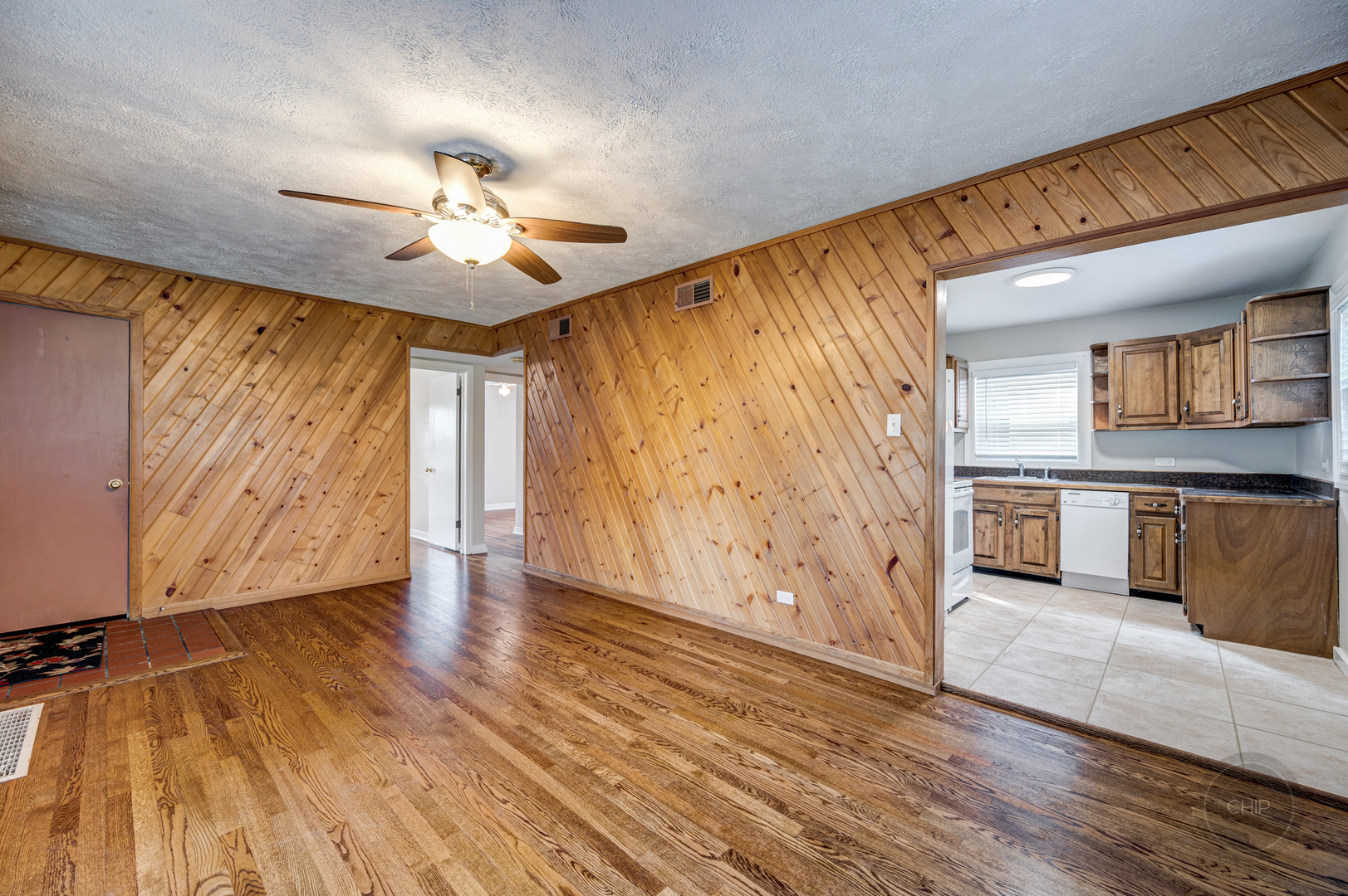 843 Pick Street Wheaton, IL 60187 - Photo 6 of 33 a view of a kitchen with wooden floor and a ceiling fan
