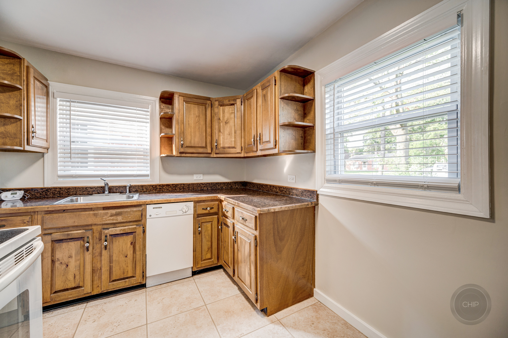 843 Pick Street Wheaton, IL 60187 - Photo 7 of 33 a kitchen with stainless steel appliances granite countertop a stove a sink and a microwave