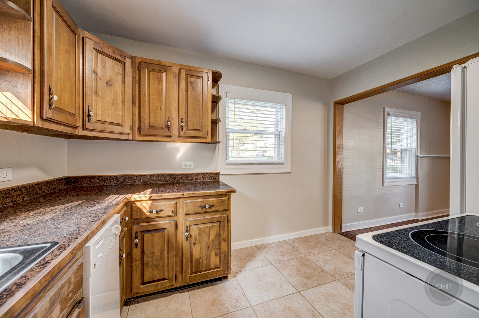 843 Pick Street Wheaton, IL 60187 - Photo 9 of 33 a kitchen with granite countertop a sink stove and cabinets