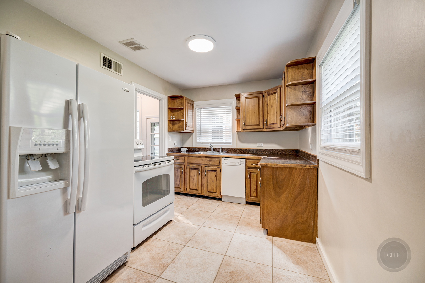 843 Pick Street Wheaton, IL 60187 - Photo 10 of 33 a kitchen with stainless steel appliances a refrigerator sink and cabinets